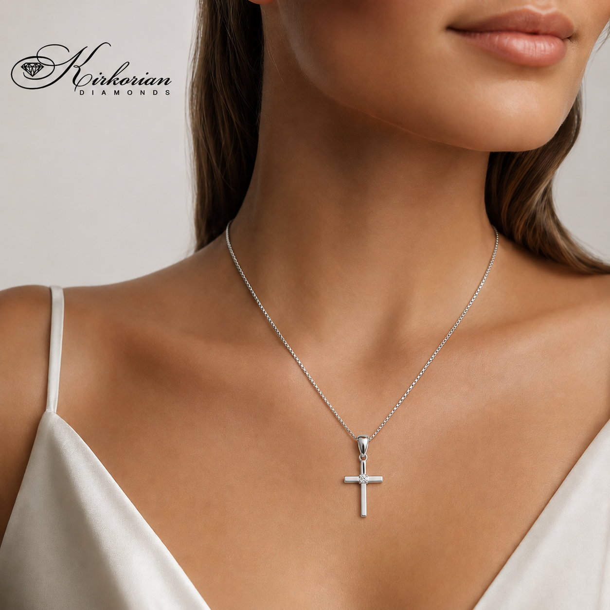 Дамски модел, носещ кръст от бяло злато 14K с естествен диамант 0.015 ct – изискано колие VS007 от Kirkorian Diamonds