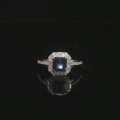 Видео на луксозен годежен пръстен от бяло злато 14К със сапфир Emerald Cut 1.31 карата и естествени диаманти с общо тегло 0.31 карата модел LR3712S от Kirkorian Diamonds. Централният син сапфир с правоъгълна Emerald шлифовка е подчертан от блестящи естествени брилянти, създаващи впечатляващ контраст, изключителен блясък и елегантна визия. Изискан пръстен, подходящ за предложение за брак, годишнина или специален подарък.